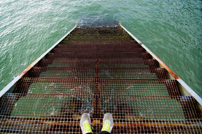 Low section of man standing on boat