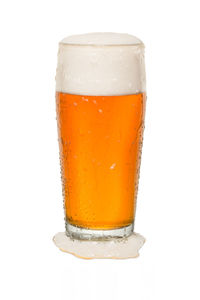 Close-up of beer glass against white background