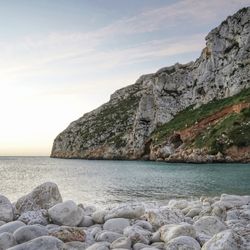 Rocks on beach against sky