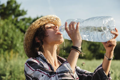 Portrait of woman drinking water