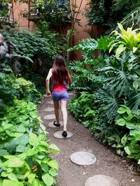 Rear view of young woman walking in park