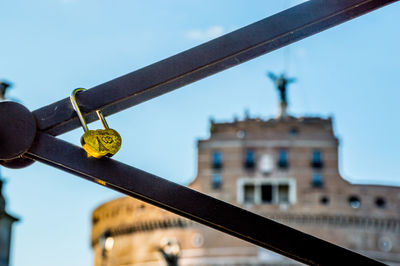 Low angle view of metallic structure against buildings in city