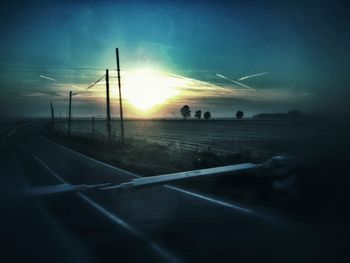 Scenic view of field against sky at sunset