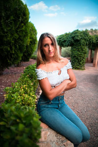 Portrait of beautiful woman against plants