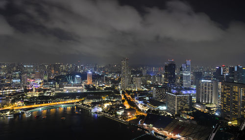 High angle view of illuminated buildings against sky at night