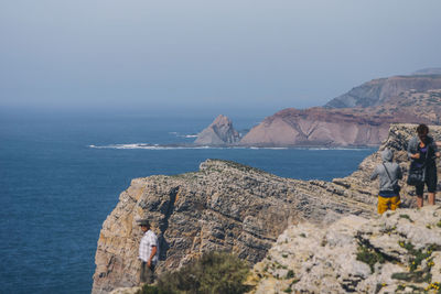 Rear view of woman by sea against clear sky