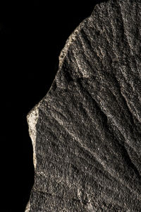 Close-up of rock formation against black background