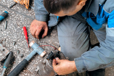 Midsection of man working at workshop