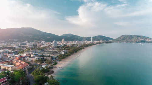 High angle view of townscape by sea against sky