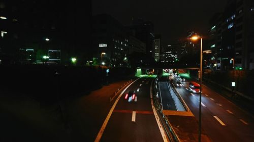 Illuminated city street at night