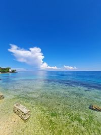 Scenic view of sea against blue sky
