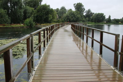 Wooden footbridge over lake