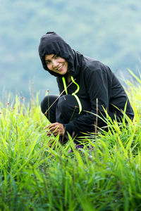 Portrait of smiling young woman in grass