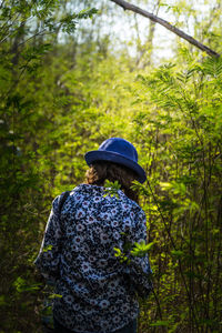 Rear view of woman walking in forest