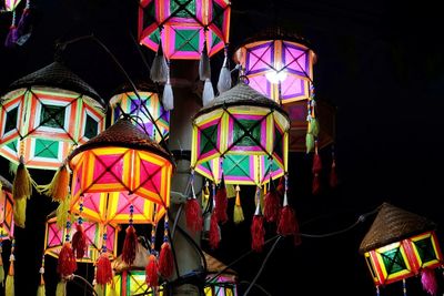 Low angle view of lanterns hanging in market at night