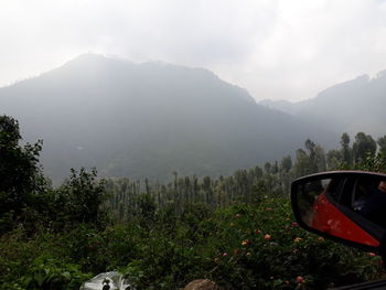 Car on mountain against sky during foggy weather