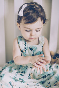 Cute baby girl sitting at home