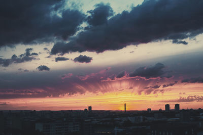 Silhouette buildings against sky during sunset