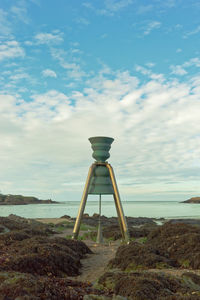 Lifeguard hut on beach against sky