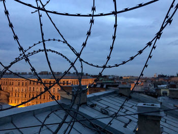 View of the city and sky through the barbed wire, the concept of non-freedom. st. petersburg, russia