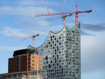 Low angle view of building against cloudy sky