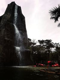 Scenic view of waterfall against sky