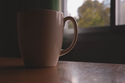 Close-up of coffee cup on table