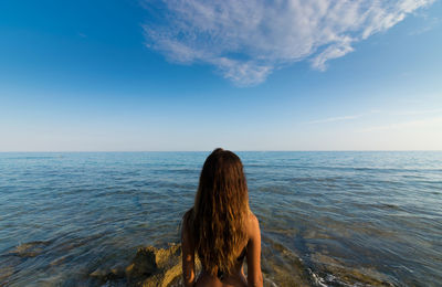 Rear view of women against sea 