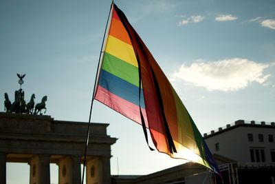 Low angle view of rainbow flag at brandeburger gate in berlin