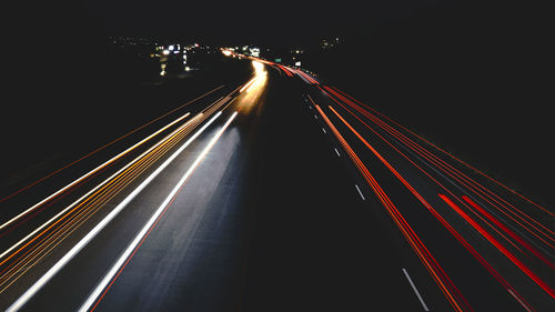 High angle view of light trails on road at night