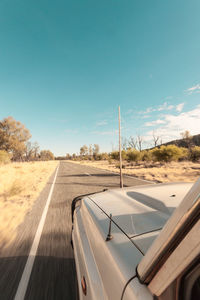 Road in desert against clear blue sky
