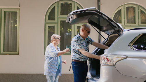 Side view of mother and daughter in car