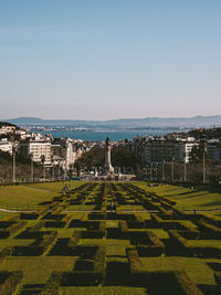 Scenic view of ornamental garden in city against clear sky