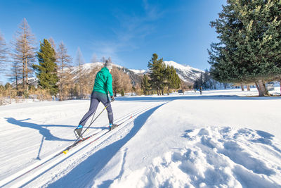 Man skiing on snow covered landscape
