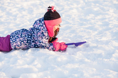 Low angle view of girl playing in snow