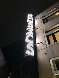 Low angle view of modern building against sky at night