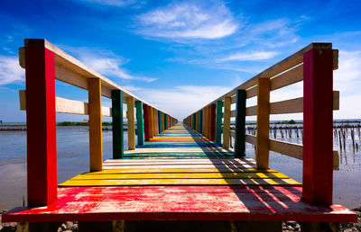 Rainbow bridge in of the colorful wood bridge extends into the sea 