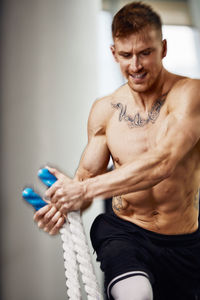 Young man exercising in gym