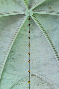 Low angle view of light fixture on wall of building