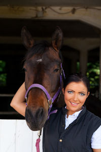 Portrait of young woman with horse