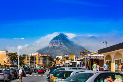 Cars on road against blue sky