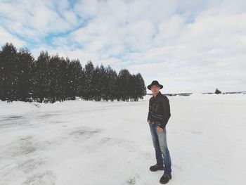 Full length of woman standing on snow covered land