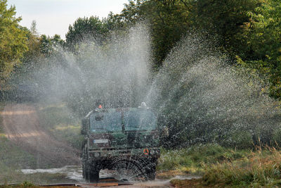 Vehicle splashing water on road