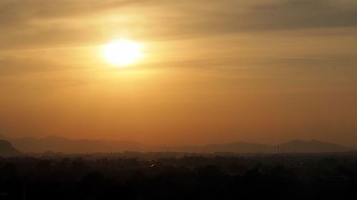 Scenic view of silhouette mountains against sky during sunset