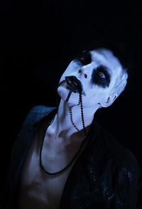 Portrait of young man over black background