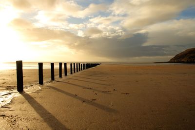 Scenic view of beach against sky during sunset