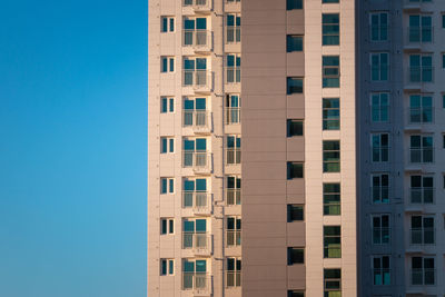 Low angle view of building against clear blue sky