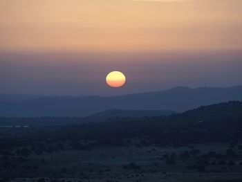 Scenic view of silhouette landscape against romantic sky at sunset