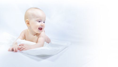 Close-up of cute baby boy against white background