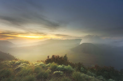 Scenic view of mountains against sky during sunset